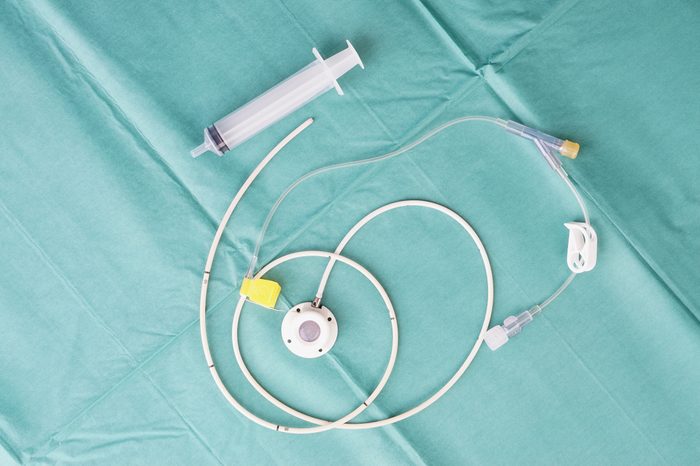 Port for a catheter or central venous port insertion, puncture at chest wall to aorta artery a medical device as silicone cartridges, has flexible tube with needle and syringe.
