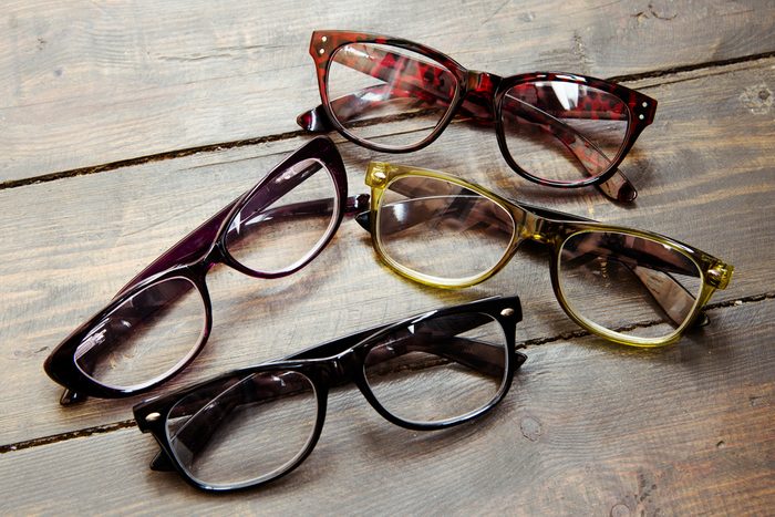 reading glasses on wooden background